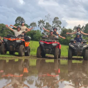 Group on ATVs reflected in the water during the 18 km route in Brotas