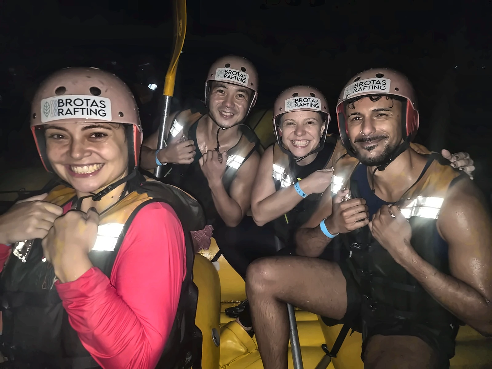 Friends with Brotas Rafting helmets and reflective life jackets during Night Rafting