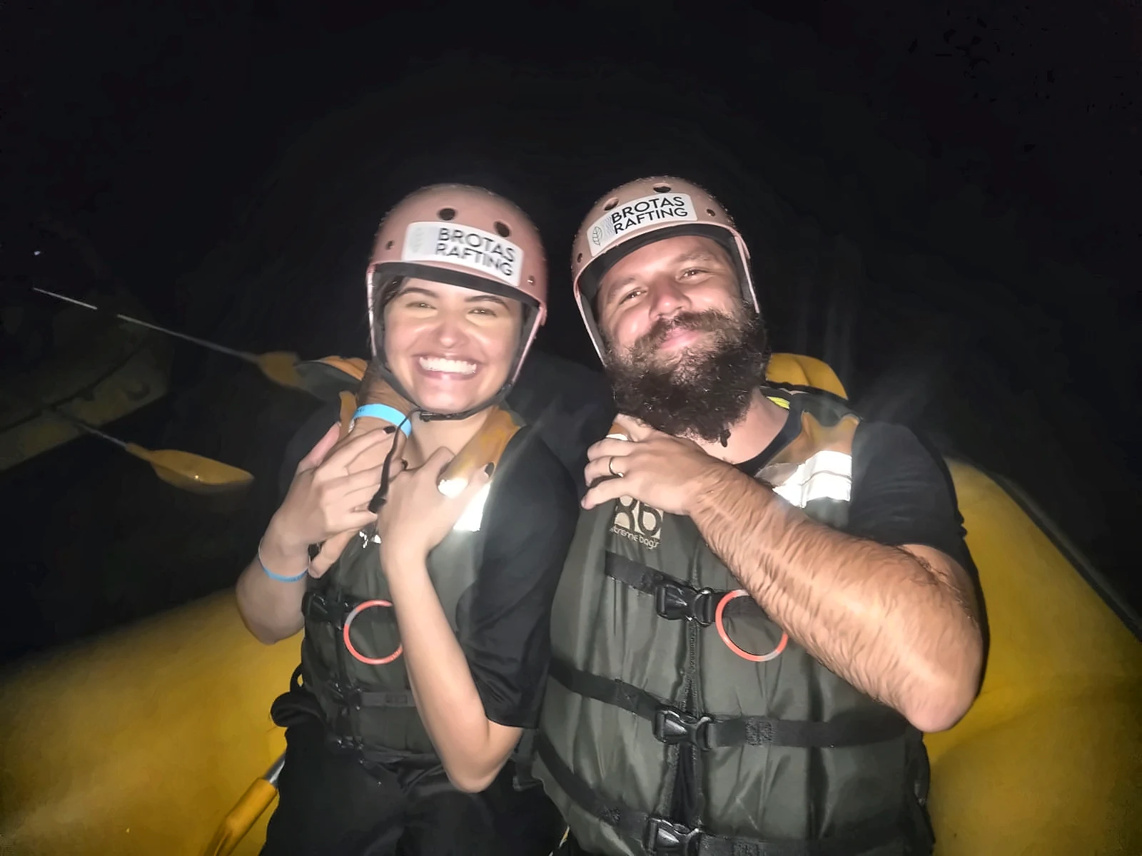 Couple smiling in the boat during Night Rafting in Brotas