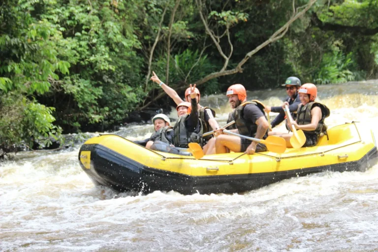 Boat with a participant with a leg amputation going down a rapid while rafting in Brotas, with the guide